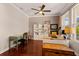 Comfortable home office with a ceiling fan, stylish desk, and shelving for decor and storage at 4617 Garden Arbor Way, Bradenton, FL 34203