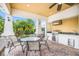 Outdoor kitchen with stainless steel grill, granite countertop, sink, and comfortable seating for outdoor dining at 4617 Garden Arbor Way, Bradenton, FL 34203