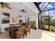 Covered patio with dining table, ceiling fans, and views of the backyard at 4617 Garden Arbor Way, Bradenton, FL 34203