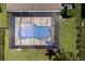 Aerial view of a screened in pool and an expansive backyard surrounded by lush landscaping at 4617 Garden Arbor Way, Bradenton, FL 34203