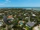 Breathtaking aerial view of the waterfront community with lush greenery, private docks, and stunning ocean views at 4831 Primrose Path, Sarasota, FL 34242