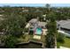 Aerial view showcasing the private pool and waterfront access, surrounded by mature trees at 4831 Primrose Path, Sarasota, FL 34242