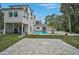 Spacious backyard featuring an inviting pool, lush landscaping, and a patio at 4831 Primrose Path, Sarasota, FL 34242