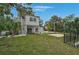 Well-maintained backyard with lush greenery, a pool, patio, and privacy fence at 4831 Primrose Path, Sarasota, FL 34242