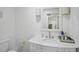 All-white bathroom with modern vanity and decor at 4831 Primrose Path, Sarasota, FL 34242