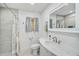 Neutral colored bathroom with tile shower and decorative shower curtain at 4831 Primrose Path, Sarasota, FL 34242