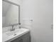 Powder room featuring a modern vanity with gray cabinets at 4831 Primrose Path, Sarasota, FL 34242