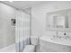 Stylish bathroom with tiled shower and glass door, sleek vanity, and a framed mirror at 4831 Primrose Path, Sarasota, FL 34242