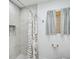 Neutral colored bathroom with tile shower and decorative shower curtain at 4831 Primrose Path, Sarasota, FL 34242