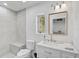 Stylish bathroom with gray tiled shower, sleek vanity, and a framed mirror at 4831 Primrose Path, Sarasota, FL 34242