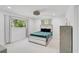 Bright bedroom with a modern bed and large window overlooking greenery at 4831 Primrose Path, Sarasota, FL 34242