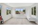 Bright bedroom with hardwood floors and multiple windows with outdoor views at 4831 Primrose Path, Sarasota, FL 34242