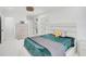 Bright bedroom with a closet, ensuite bathroom, and plush bed with a pizza pillow at 4831 Primrose Path, Sarasota, FL 34242