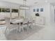 Bright dining room with a contemporary light fixture, stylish furniture, and decor at 4831 Primrose Path, Sarasota, FL 34242