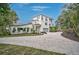 Charming two-story home featuring a paved driveway, attached garage, and lush landscaping at 4831 Primrose Path, Sarasota, FL 34242