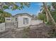Charming home exterior with stucco siding, shutters, and lush landscaping at 4831 Primrose Path, Sarasota, FL 34242