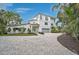 Beautiful two-story home featuring a well-manicured lawn and an expansive paved driveway at 4831 Primrose Path, Sarasota, FL 34242