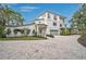 Inviting exterior showcasing a two-story facade, manicured lawn, and a welcoming front entrance at 4831 Primrose Path, Sarasota, FL 34242