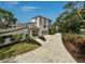 Elegant home with lush landscaping, a spacious driveway, and an attached two-car garage at 4831 Primrose Path, Sarasota, FL 34242