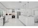 Bright kitchen with white cabinets, stainless steel appliances, and a view of the backyard at 4831 Primrose Path, Sarasota, FL 34242
