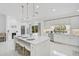 Bright kitchen features an island with bar seating and modern appliances at 4831 Primrose Path, Sarasota, FL 34242