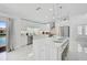 Bright kitchen with white cabinetry, stainless steel appliances, and a large center island at 4831 Primrose Path, Sarasota, FL 34242