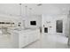 Bright open concept kitchen with a large island, bar fridge, and pendant lighting at 4831 Primrose Path, Sarasota, FL 34242