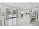 Bright and airy modern kitchen with an island, stainless steel appliances, and views of the pool at 4831 Primrose Path, Sarasota, FL 34242
