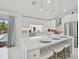 Modern kitchen featuring an island with seating, stainless steel appliances, and ample cabinet space at 4831 Primrose Path, Sarasota, FL 34242