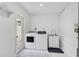 Laundry room with modern machines, white cabinets, and ample natural light at 4831 Primrose Path, Sarasota, FL 34242