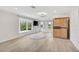 Bright living room with custom wood cabinet, hardwood floors and large windows at 4831 Primrose Path, Sarasota, FL 34242