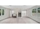 Open living room featuring a staircase, windows, and wood floors at 4831 Primrose Path, Sarasota, FL 34242