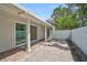 This brick patio features large sliding doors and plenty of space for outdoor lounging at 4831 Primrose Path, Sarasota, FL 34242