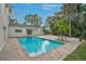 Inviting backyard pool with brick pavers, the house and palm trees surrounding it at 4831 Primrose Path, Sarasota, FL 34242