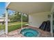 Inviting covered spa area with brick pavers and access to the lawn at 4831 Primrose Path, Sarasota, FL 34242