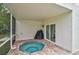 Inviting covered spa area with brick pavers and access to the home at 4831 Primrose Path, Sarasota, FL 34242