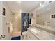This bathroom has a tub and shower combination with a lovely granite vanity at 4832 Independence Dr, Bradenton, FL 34210