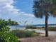 Scenic view of a pristine beach with clear turquoise water and lush greenery framing the shoreline at 4832 Independence Dr, Bradenton, FL 34210