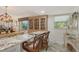 Attractive breakfast bar area that features a breakfast bar with seating and glass cabinet, illuminated by a warm light at 4832 Independence Dr, Bradenton, FL 34210