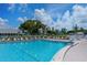 Large community pool with plenty of lounge chairs and a manicured fence-lined perimeter at 4832 Independence Dr, Bradenton, FL 34210