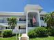 Charming two-story condo featuring a welcoming entrance and well-maintained landscaping at 4832 Independence Dr, Bradenton, FL 34210