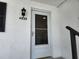 This home boasts a bright white front door, an updated light fixture, and clearly displayed address numbers at 4832 Independence Dr, Bradenton, FL 34210