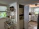 Well-lit kitchen features white cabinetry, granite counters, and a closet with a washer and dryer at 4832 Independence Dr, Bradenton, FL 34210