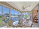 The bright sunroom includes a seating area with water views for enjoying the beautiful weather and scenery at 4832 Independence Dr, Bradenton, FL 34210