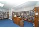 Library featuring extensive bookshelves, tables, and chairs at 4832 Independence Dr, Bradenton, FL 34210
