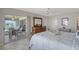Relax in this main bedroom with a peaceful view of the lanai and lake at 4832 Independence Dr, Bradenton, FL 34210
