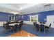 Meeting room with tables, chairs, and stylish blue walls and nautical decor at 4832 Independence Dr, Bradenton, FL 34210