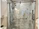 Modern tiled shower featuring a glass door and multiple showerheads, offering a spa-like experience at 4832 Independence Dr, Bradenton, FL 34210