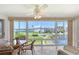 Bright sunroom with panoramic views of the landscaped grounds and waterfront at 4832 Independence Dr, Bradenton, FL 34210