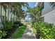 Follow the walkway to a charming condo, surrounded by lush tropical landscaping and vibrant flowers at 4832 Independence Dr, Bradenton, FL 34210